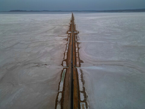 Drone shot of the surreal &ldquo;Road to Heaven&rdquo; stretching across the vast salt desert of Kutch, India.
