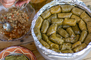 Grandma prepares traditional dolma in the country, abroad, in the Republic of Moldova or Romania. Dolma is a family of stuffed dishes associated with Ottoman cuisine.