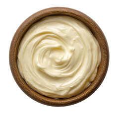 Creamy yellow condiment swirled in a rustic wooden bowl, top-down view on black