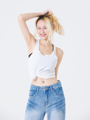 Asian confident beautiful young woman blonde hair high tied  standing wearing sleeveless top jeans...