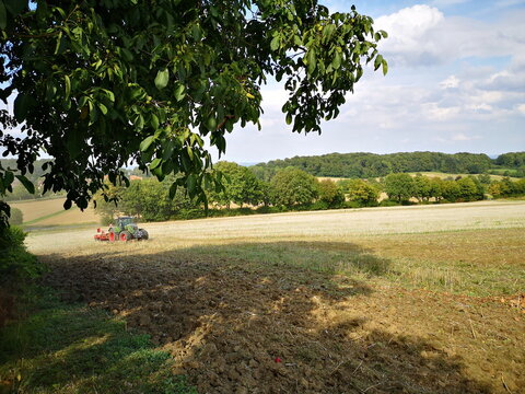 Fendt Farmer 718 Vario Traktor mit Pflug beim Pfl&uuml;gen des Acker mit Staubwolke am 27..08.2025 Vorm Obernberge in Oerlinghausen bei Bielefeld am Hermannsweg im Teutoburger Wald in Ostwestfalen-Lippe