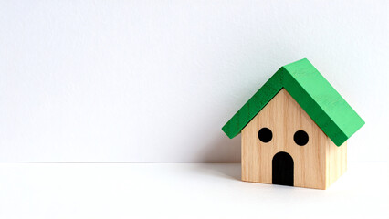 Small wooden house with green roof