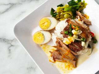 Close up of pork leg rice without skin and one cut egg. A popular Thai-Chinese food. Natural light and top view.