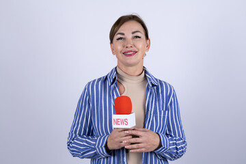 A reporter is holding a microphone for a news report