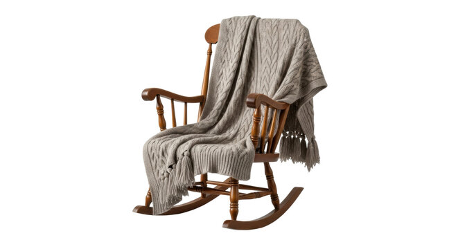 A traditional wooden rocking chair with a high back is elegantly draped with a cozy beige cable-knit throw blanket, evoking a feeling of warmth, comfort, and relaxation