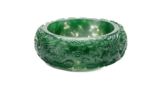 An ornate, wide green jadeite bangle intricately carved with a traditional mythical dragon motif, showcasing exquisite craftsmanship and the beautiful translucent quality of the gemstone