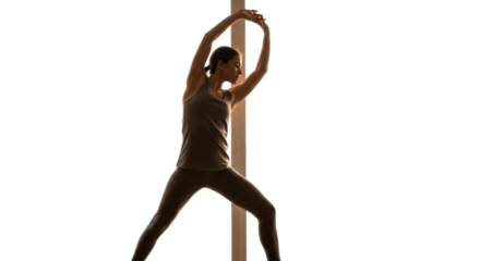 A focused woman in athletic wear performs a standing side bend stretch with her eyes closed, her graceful silhouette beautifully illuminated by warm, dramatic rim lighting