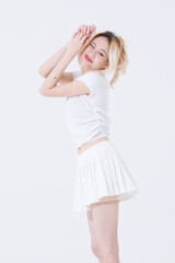 Asian confident attractive beautiful young woman blonde hair tied stand wearing white shirt top mini skirt sport background studio, portrait lifestyle fashion outfit trendy style pose look at camera.