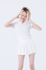 Asian confident attractive beautiful young woman blonde hair tied stand wearing white shirt top mini skirt sport background studio, portrait lifestyle fashion outfit trendy style pose look at camera.