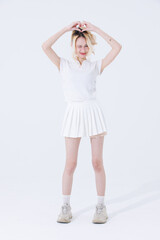 Naklejka premium Asian confident attractive beautiful woman blonde hair tied stand wear white shirt top mini skirt sport on background studio portrait fashion street outfit trendy style pose look at camera full length