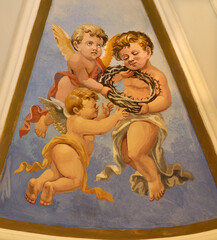 Obraz premium PRAIANO, ITALY - OCTOBER 6, 2025: The fresco of angels with the instruments of crucifixion (crown of thorns) in the side cupola of church Chiesa di san Gennaro by unknown artist of 20. cent. 
