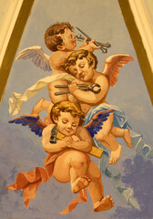 Obraz premium PRAIANO, ITALY - OCTOBER 6, 2025: The fresco of angels with the instruments of crucifixion in the side cupola of church Chiesa di san Gennaro by unknown artist of 20. cent. 