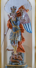 Obraz premium PRAIANO, ITALY - OCTOBER 6, 2025: The carved polychrome baroque statu of St. Michael Archangel in the church Chiesa di san Gennaro by unknown abaroque artist.