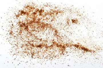 Ground chicory root scattered on a white background.