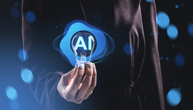 Person holding glowing AI lightbulb with digital elements and bokeh effects on dark blue background, symbolizing artificial intelligence innovation concept.