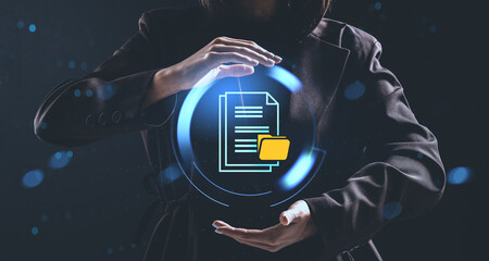 Woman presenting digital file icon with glowing circular interface in futuristic data management concept on dark background with floating light particles.