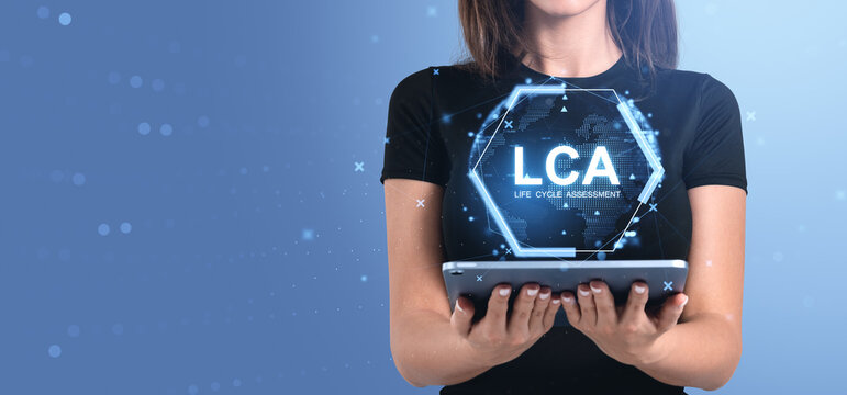 Woman holding tablet with LCA Life Cycle Assessment digital inte