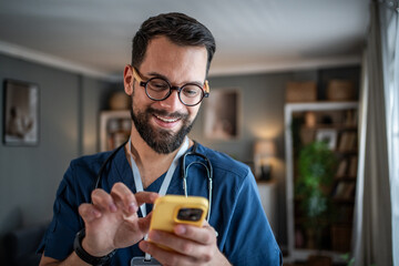 Male healthcare professional using phone for telemedicine consultation