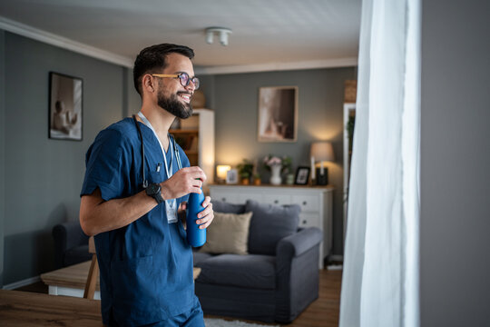 Male healthcare worker relaxing at home during break - Powered by Adobe