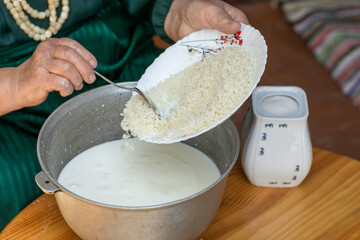 Countryside Cooking Scene. Elderly Woman Preparing Classic Homemade Meals Outside. Grandma Making Traditional Family Dishes. Rural Heritage Cuisine in Moldova.