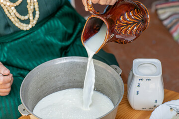 Countryside Cooking Scene. Elderly Woman Preparing Classic Homemade Meals Outside. Grandma Making Traditional Family Dishes. Rural Heritage Cuisine in Moldova.