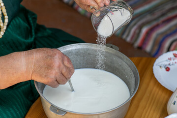 Countryside Cooking Scene. Elderly Woman Preparing Classic Homemade Meals Outside. Grandma Making Traditional Family Dishes. Rural Heritage Cuisine in Moldova.