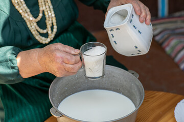 Countryside Cooking Scene. Elderly Woman Preparing Classic Homemade Meals Outside. Grandma Making Traditional Family Dishes. Rural Heritage Cuisine in Moldova.