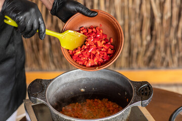 Countryside Cooking Scene. Elderly Woman Preparing Classic Homemade Meals Outside. Grandma Making Traditional Family Dishes. Rural Heritage Cuisine in Moldova.
