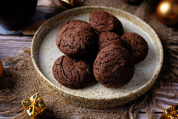 Chocolate chip cookies in a plate for the Christmas holidays on a wood background