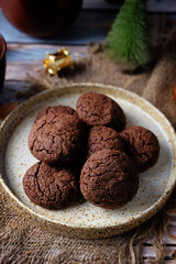 Chocolate chip cookies in a plate for the Christmas holidays on a wood background