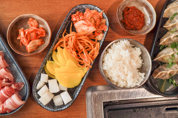 Close-up of kimchi, banchan, and other Korean appetizers in a restaurant. Fermented food
