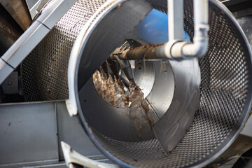 The interior of a pre-wash drum at a starch production plant. Wet potato pulp, dirt, and soil...