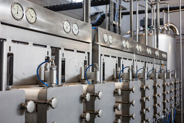 A large hydrocyclone battery at a potato starch factory. This modern stainless steel equipment is used for the multi-stage washing, refining, and concentration of starch milk, many pressure gauges