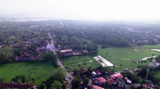 Houses with trees and Our Lady of Merces Church at goa, day time, push in shot, drone shot, 4k.