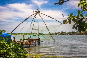 Fort kochi area with restaurants water metro Chinese fishing nets and cargo port activities