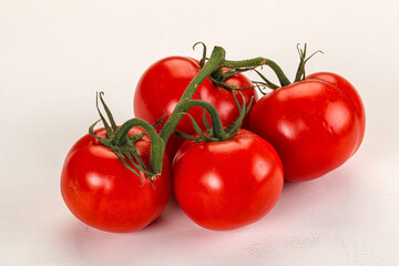 Ripe fresh tomato on the branch