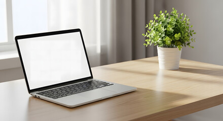 Digital Workspace: A modern laptop rests on a light wooden desk, adjacent to a vibrant green potted plant by a window, fostering productivity and tranquility.