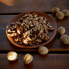 Freshly shelled walnuts on a rustic wooden table in warm afternoon light