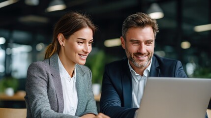 Collaborative Insights: A focused professional couple, immersed in a collaborative environment, reviews data, sharing insights and ideas using technology.