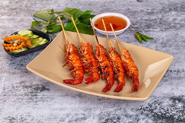 Grilled prawn skewer served sauce