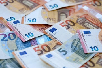 Euro money bills banknotes in big amount on table close up. Huge quantity of European Union currency cash on smooth surface. Business and rich life concept