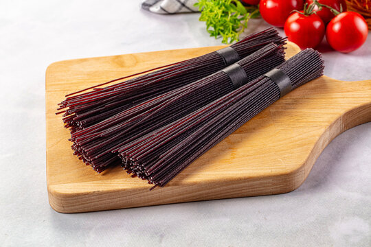Raw black rice noodles lines - Powered by Adobe