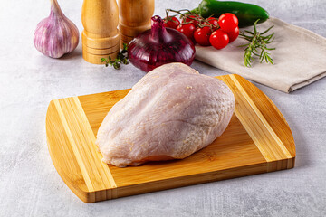 Raw chicken breast with bone and skin