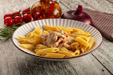 Pasta penne with chicken in cream sauce