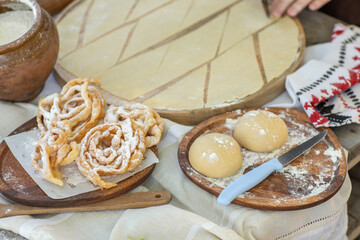 Artisan chef making authentic homemade biscuits following old Moldovan recipes. Heritage baking scene. cozy rural kitchen