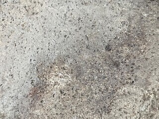 Close-up shot of a rough, textured stone surface. The image showcases the natural grain and imperfections of the rock