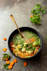 Classic meatball soup with potatoes,  carrot and greens.