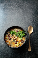 Red bean soup with potatoes, tomatoes, paprika, carrot, and bacon.
