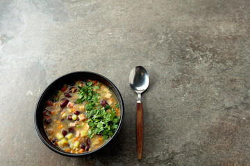 Red bean soup with potatoes, tomatoes, paprika, carrot, and bacon.