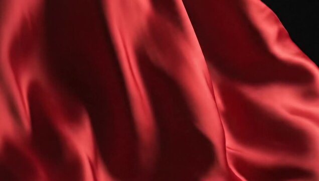Red Fabric Flowing Gracefully in Slow Motion on a Dark Background.